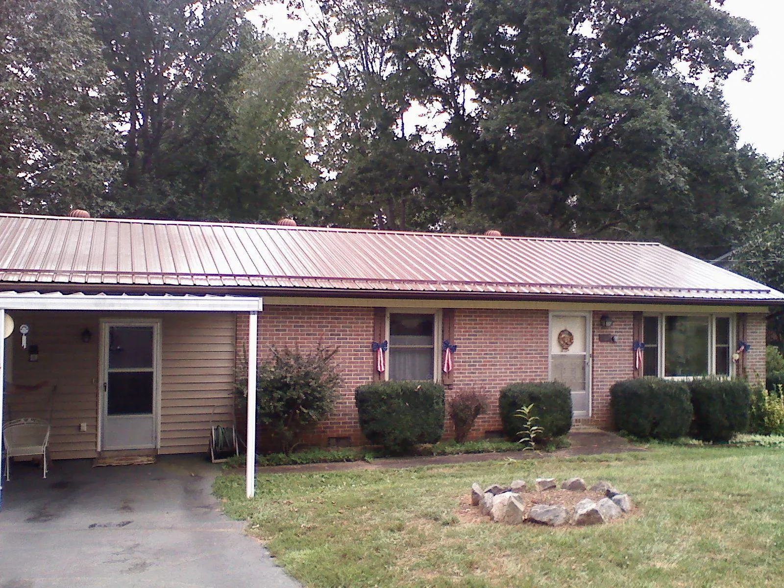 Bronze metal roof and carport on a brick ranch home — Roof Repair work by our crew in Elk Falls